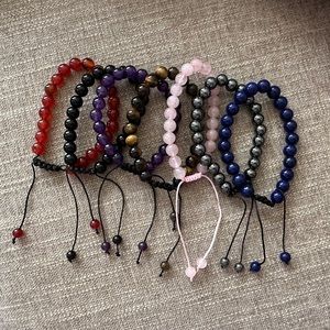 Brand new: Set of 7 crystal adjustable bracelets w/ velvet pouch